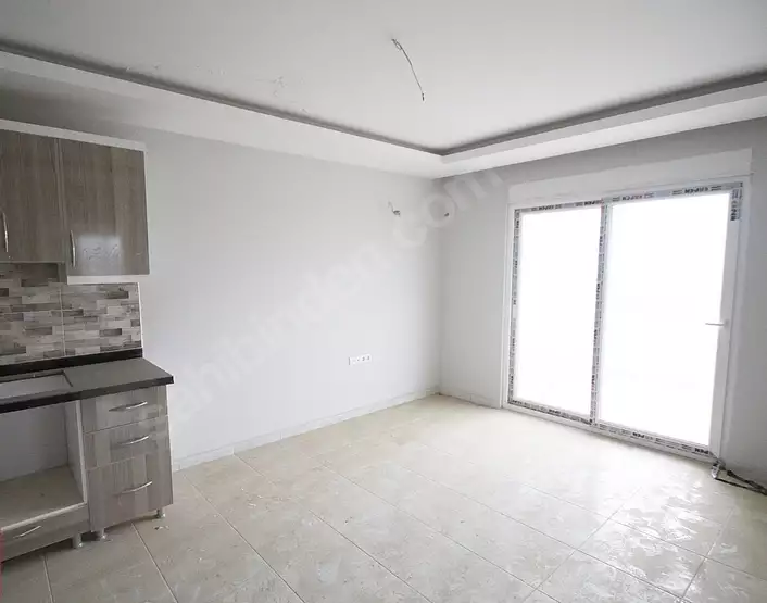 Доступное (1+1) жилье в самом интернациональном районе Алании - В МАХМУТЛАРЕ.